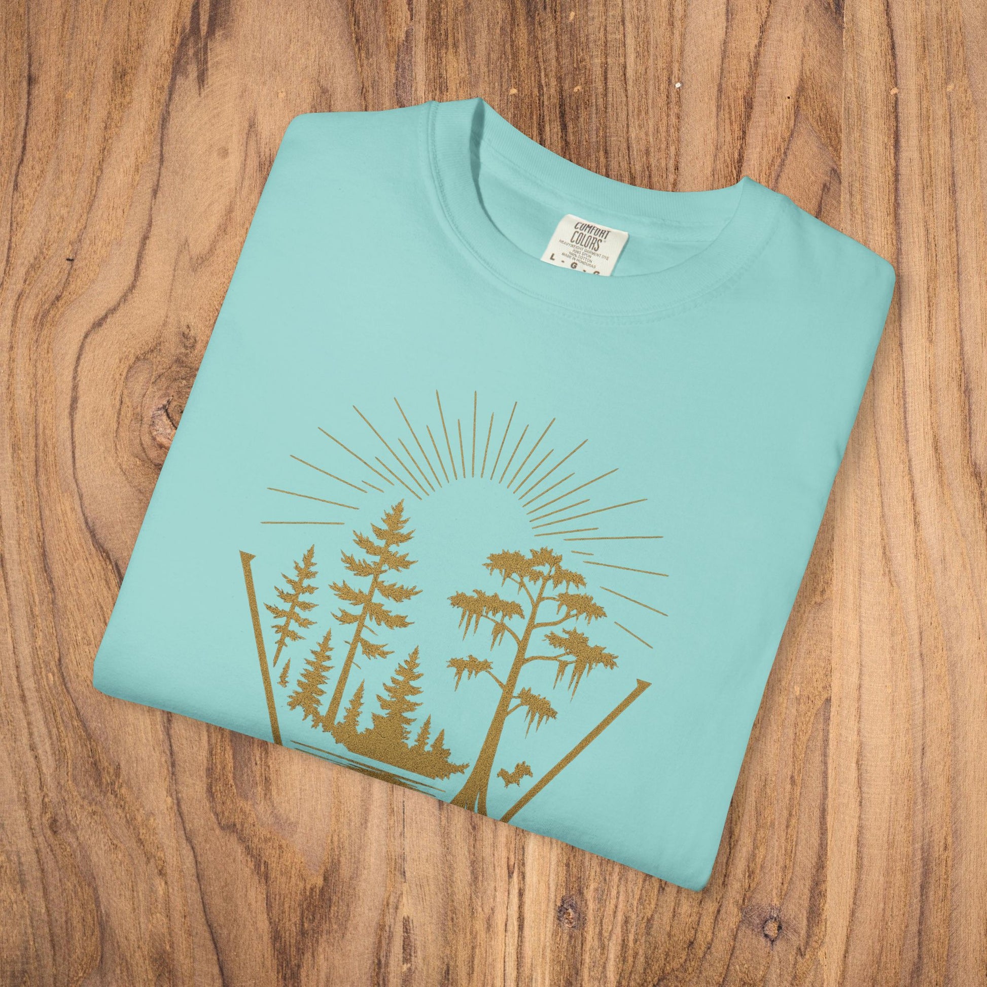 Nature Outdoor Vibes Tee - Soft 100% US Cotton, displaying a light blue fold with a nature graphic on a rustic wooden background.