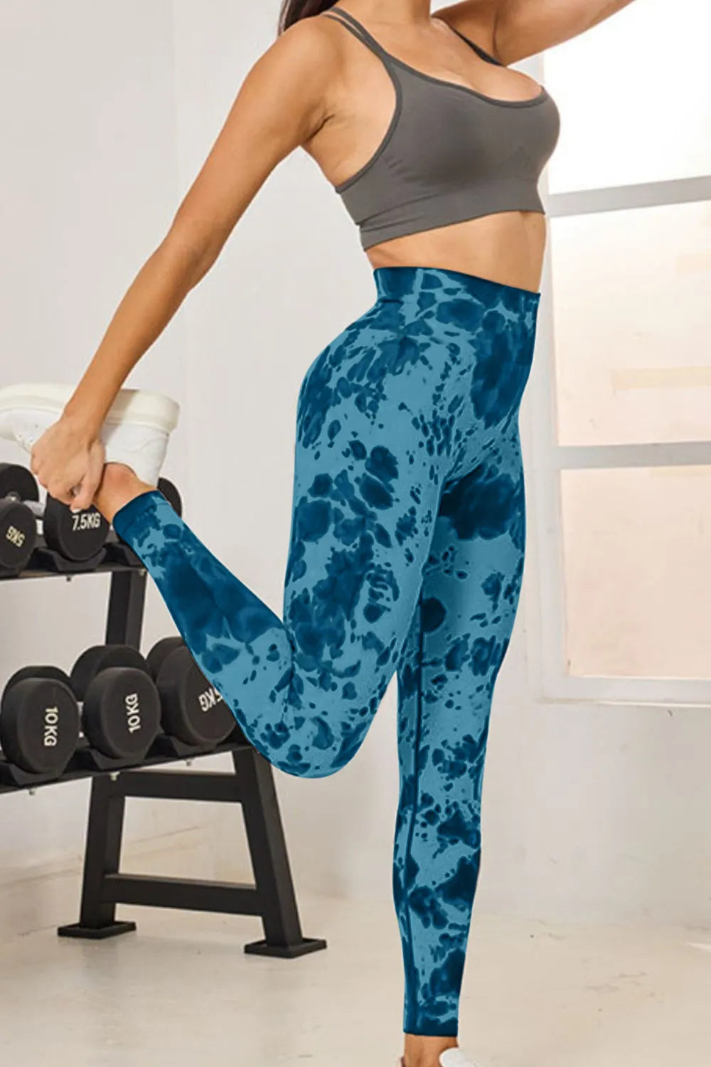 Model showcasing the slightly stretchy fabric of Tie-Dye High Waist Active Leggings in blue, ideal for fitness routines.