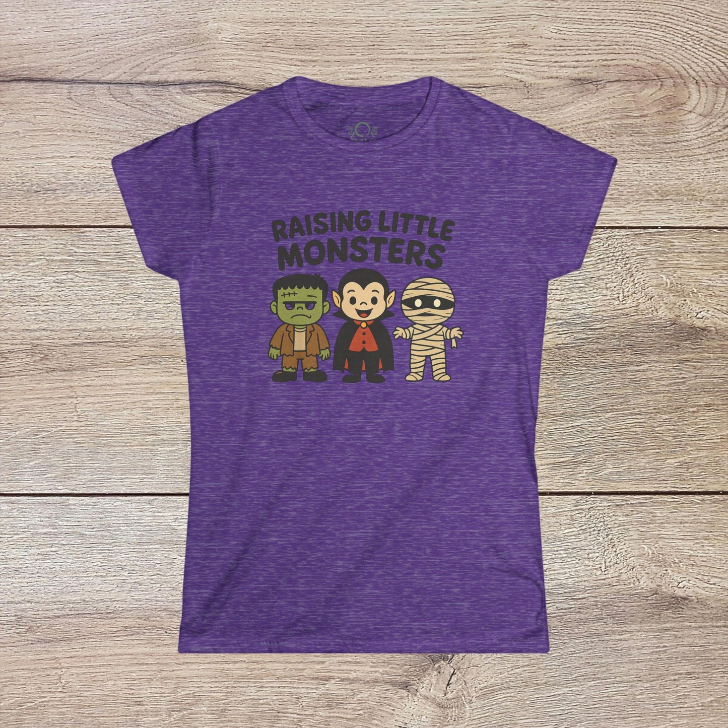 Purple Halloween Family T-Shirt showcasing playful characters of Frankenstein, a vampire, and a mummy, great for kids' Halloween celebrations - Raising Little Monsters Cute Kids Tee.