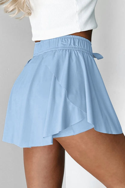 Back view of Drawstring High Waist Lined Active Skorts in light blue, displaying the elegant layered design and comfortable fit.