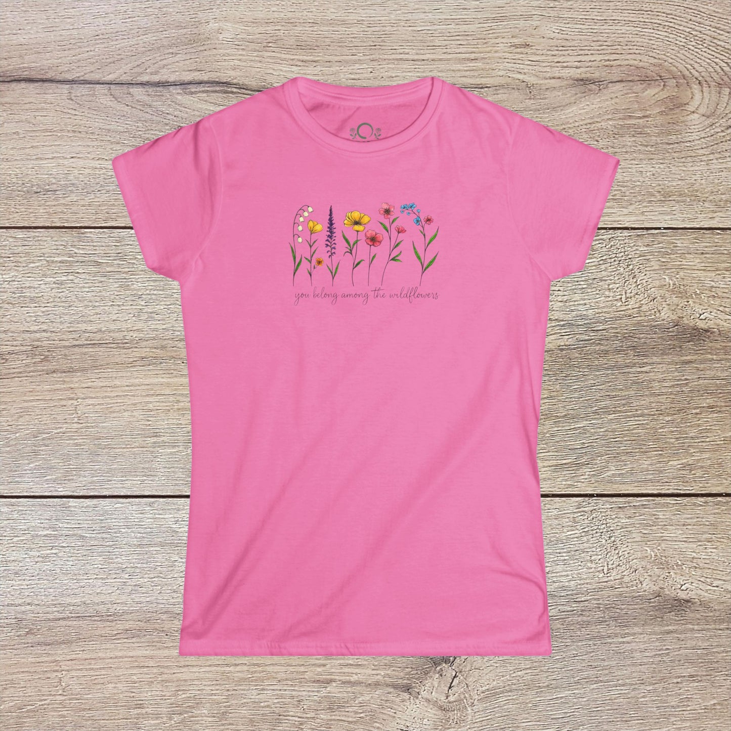Wildflowers T-Shirt in pink displaying a colorful floral design with the phrase 'you belong among the wildflowers'. Great for adding a cheerful touch to your wardrobe.