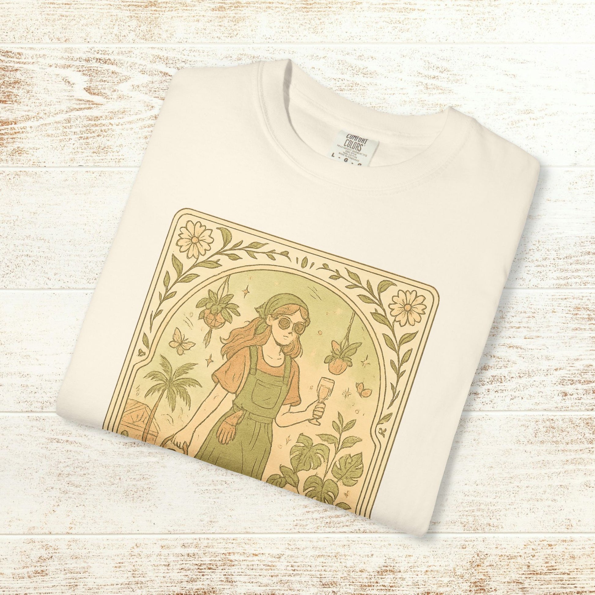 Rooted One Tarot Tee in cream color, featuring a stylish illustration of a girl with sunglasses surrounded by plants and butterflies, made from ethically sourced cotton, available in sizes S-4XL.