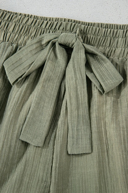 Detailed view of the tie waist for the Textured Tie Waist Ruffle Hem Shorts, emphasizing the elegant texture and chic style.