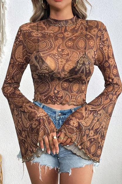 Stylish sheer printed mock neck top with flair sleeves, featuring a bohemian paisley pattern along with distressed denim shorts, perfect for a casual outfit.