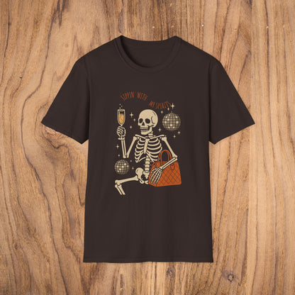 Spooky Spirits Graphic Tee in black featuring a playful skeleton holding a drink, perfect for Halloween celebrations.