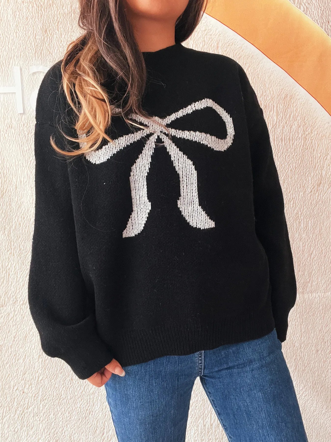 Close-up view of the Stylish Bow Pattern Casual Long Sleeve Sweater for Effortless Everyday Wear highlighting the intricate bow knit design.