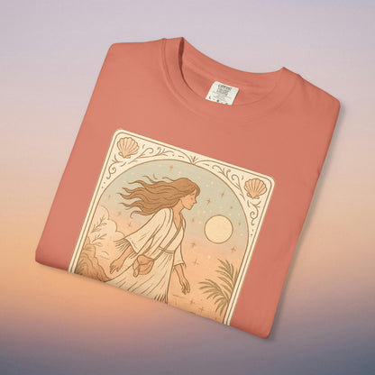 Wanderer Tarot Graphic Tee in coral color, made from ethically sourced 100% cotton, featuring a unique design of a woman walking with nature elements, perfect for sizes S to 4XL, offering style and comfort.