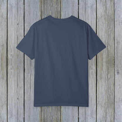 Back view of the Unisex Garment-Dyed Lake Rules Tee - Soft Vintage Fabric, Sizes S to 4XL, perfect for outdoors, showcasing its simple style against a wooden backdrop.