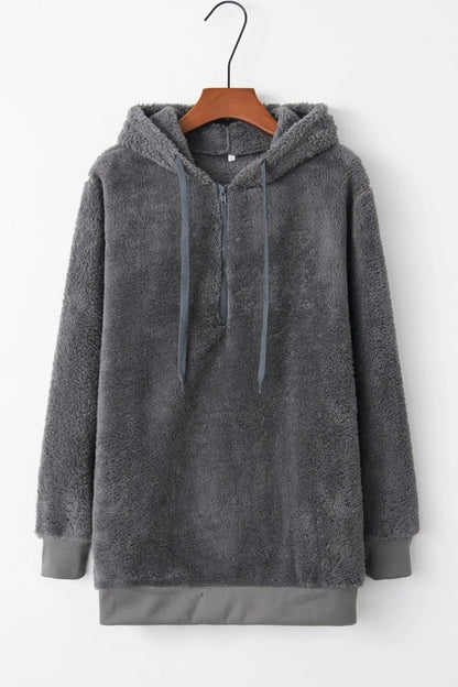 Cozy Full Size Teddy Hoodie with Quarter-Zip and Drawstring, Opaque & Slightly Stretchy, 100% Polyester, displayed on a hanger in a stylish setting.