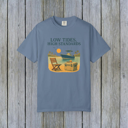Garment-Dyed Low Tides High Standards T-Shirt in blue, showcasing a laid-back beach scene with a boat and chair, ideal for casual outings.