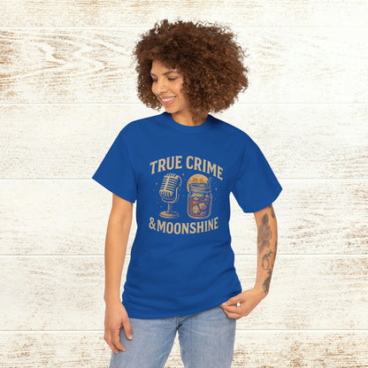 Model wearing a vibrant blue True Crime & Moonshine Unisex Graphic Tee, showcasing a fun design with a microphone and a jar, perfect for true crime lovers.