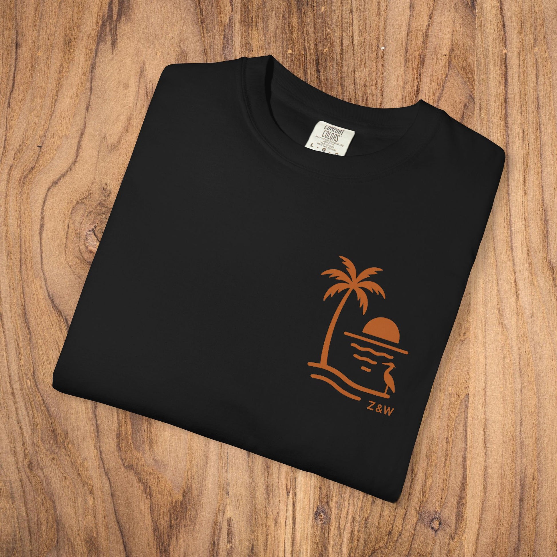Unisex Sunset Palm Tree T-Shirt - Front view of a classic black tee showcasing a palm tree sunset graphic, ideal for any occasion.