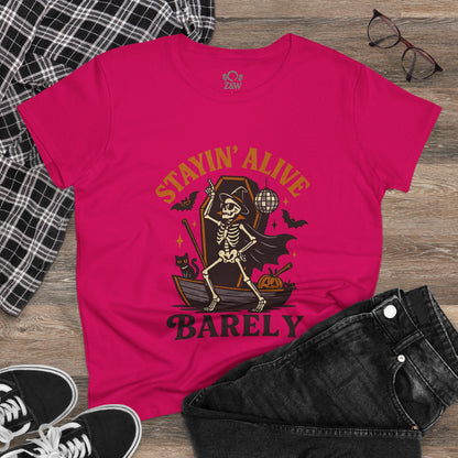 Stayin’ Alive T-Shirt, Funny Halloween Unisex Tee displayed with stylish accessories, showcasing a whimsical skeleton graphic perfect for festive occasions.