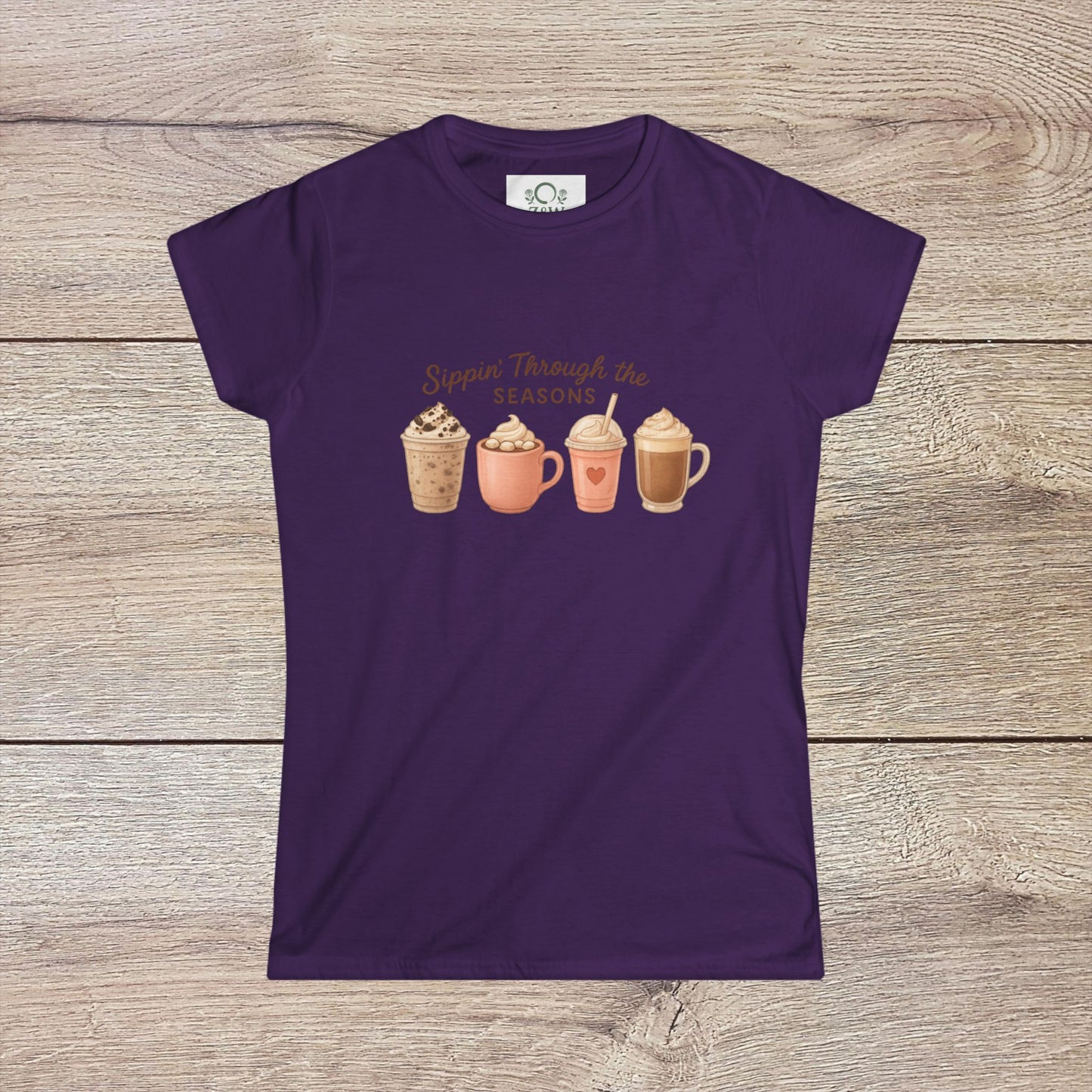 Sippin' Through The Seasons Slim Fit Tee in purple featuring four colorful coffee mugs, showcasing a fun design perfect for coffee lovers.