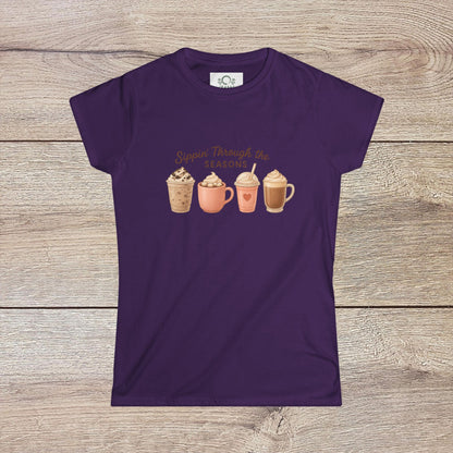 Sippin' Through The Seasons Slim Fit Tee in purple featuring four colorful coffee mugs, showcasing a fun design perfect for coffee lovers.