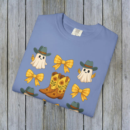 Folded Cute Halloween T-Shirt with vibrant ghosts and cowboy boots design, highlighting eco-friendly fabric. Perfect for unisex fall fashion enthusiasts.