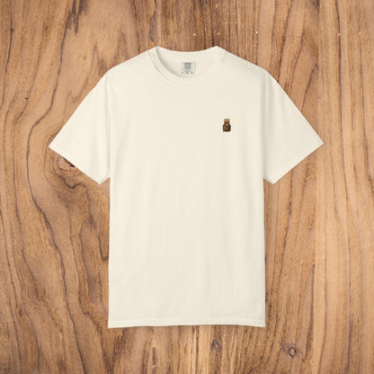 Premium Southern Made T-Shirt shown in a soft cream color on a wood surface, ideal for stylish casual wear.