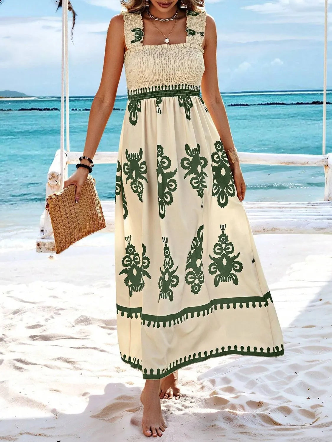 Trendsi Smocked Printed Maxi Dress with Wide Straps - Elegant Opaque, Non-Stretch Design, highlighted on a sandy beach, displaying a flowy silhouette with ruched detailing and beautiful green prints.