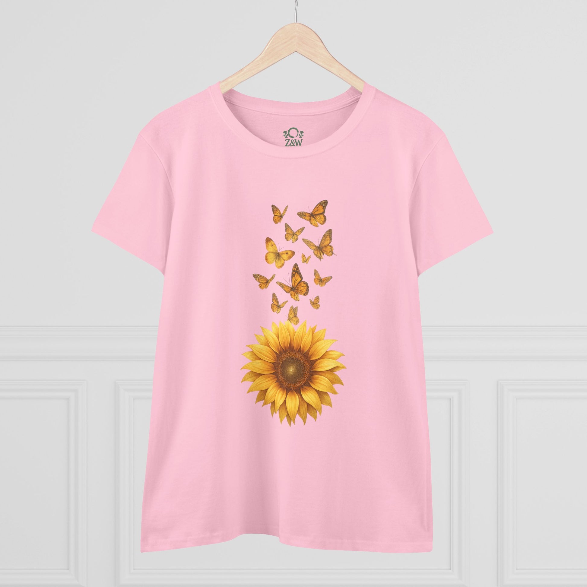 Sunflower & Butterflies Cotton Tee for Women in light pink, presented in a stylish setting with a sunflower and butterfly design, made from 100% soft cotton for a comfortable and fashionable look.