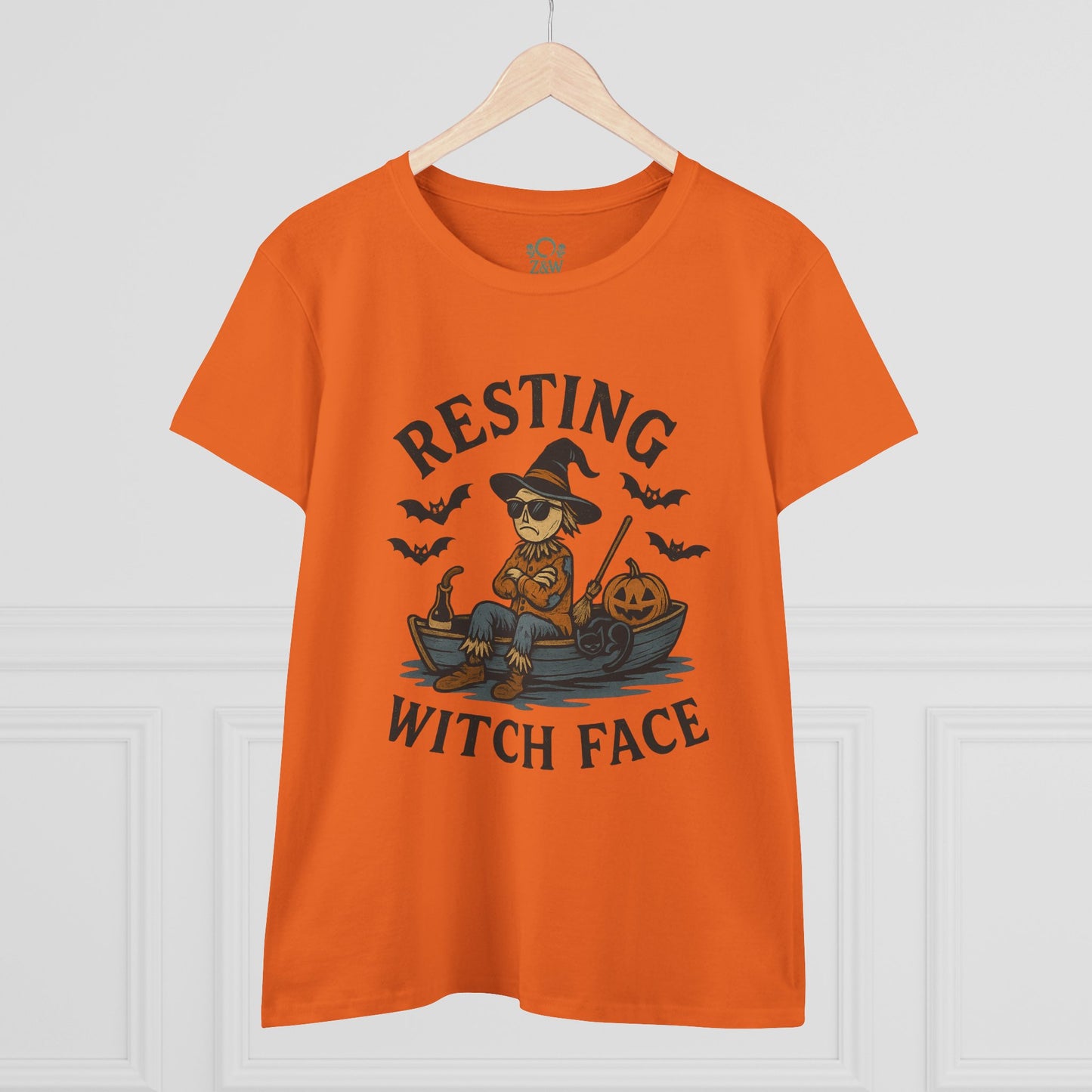 Resting Witch Face Halloween T-Shirt for Women displayed on a hanger, featuring a whimsical scarecrow and pumpkin design, perfect for Halloween celebrations and gifting.