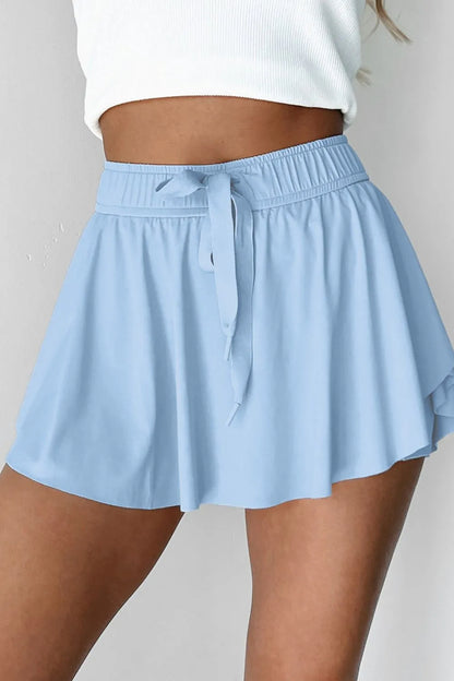 Close-up of Drawstring High Waist Lined Active Skorts in light blue, showcasing the fashionable silhouette and adjustable drawstring feature.