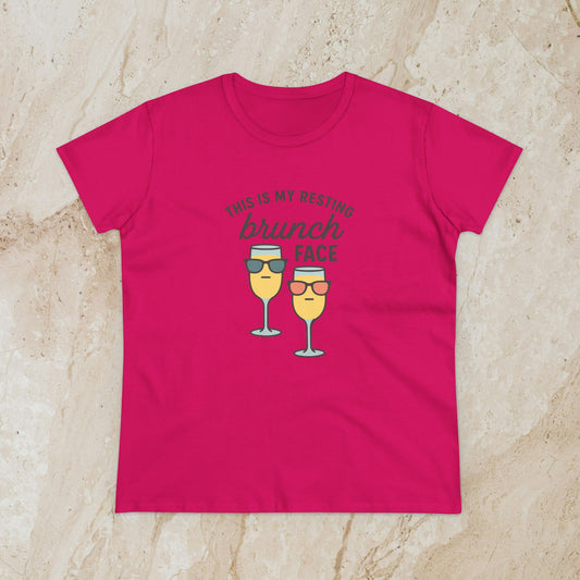 Women's Premium 100% Cotton Brunch Face Tee in vibrant pink showcasing a fun illustration of sunglasses-wearing glasses and the phrase 'This is my resting brunch face'. Ideal for stylish comfort during brunch.