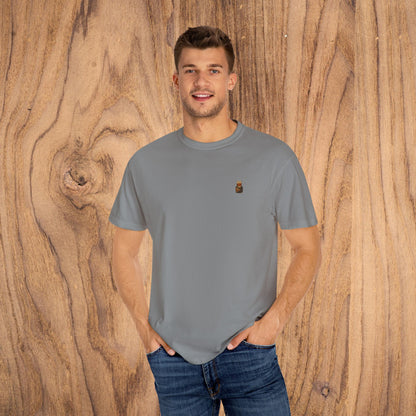 Model wearing Premium Southern Made T-Shirt in grey color, standing against a wooden background, emphasizing stylish casual wear available in various sizes.