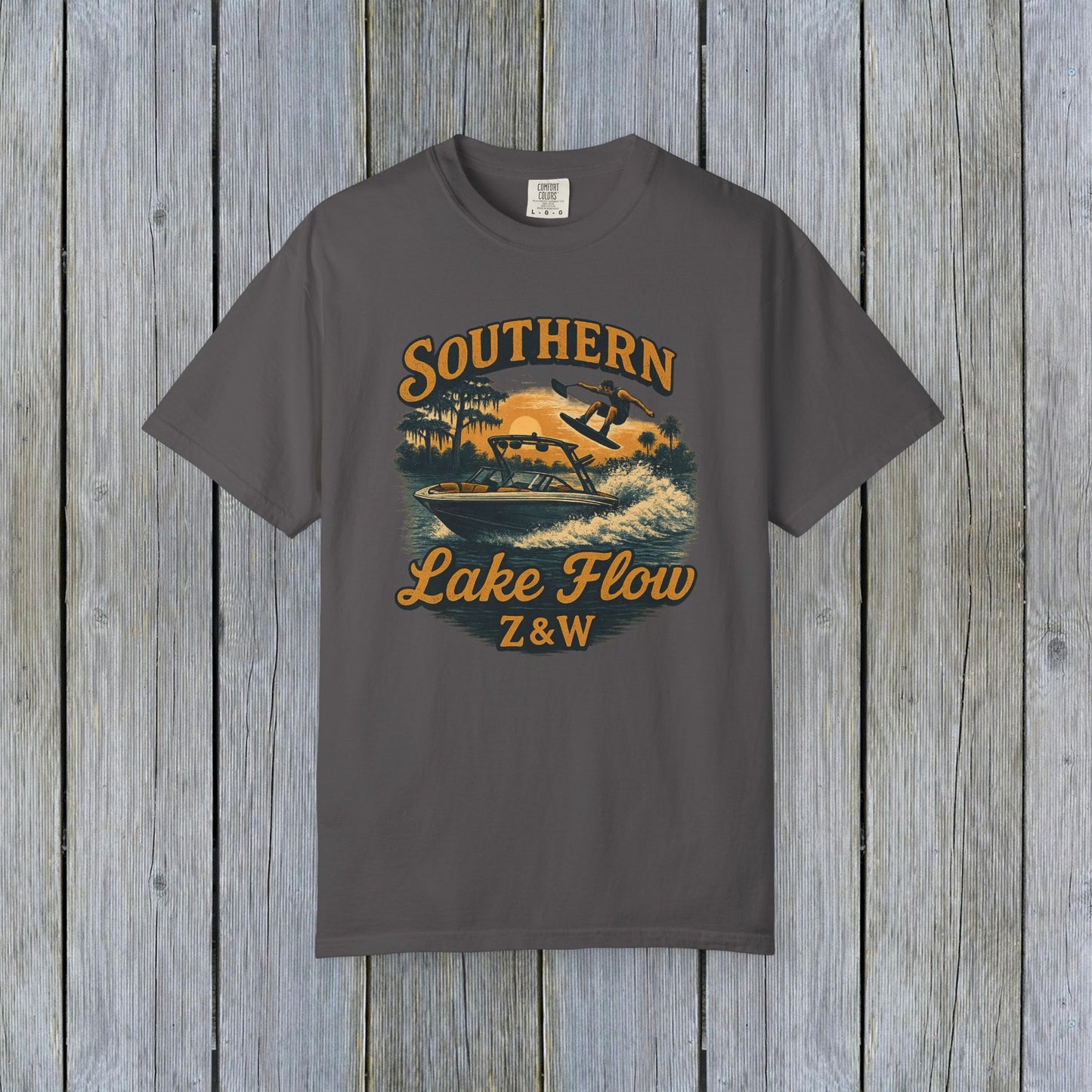 Southern Lake Flow T-Shirt in charcoal gray, featuring an eye-catching graphic of a wakeboarder on a lake, combining style and eco-friendliness for the perfect casual wear.