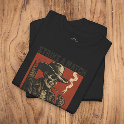 Bangtown Outlaws Retro Casual Party Shirt folded neatly in black, showing a vintage skeleton design with 'Strike a Match' caption. This unisex cotton tee combines style and comfort for perfect casual wear or gifting.