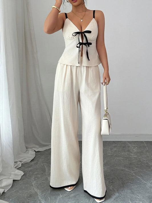 Trendy 2-Piece Tie Front Cami and Pocketed Pants Set featuring a stylish open-back design, crafted from 100% cotton with no stretch. Perfect for summer outings.