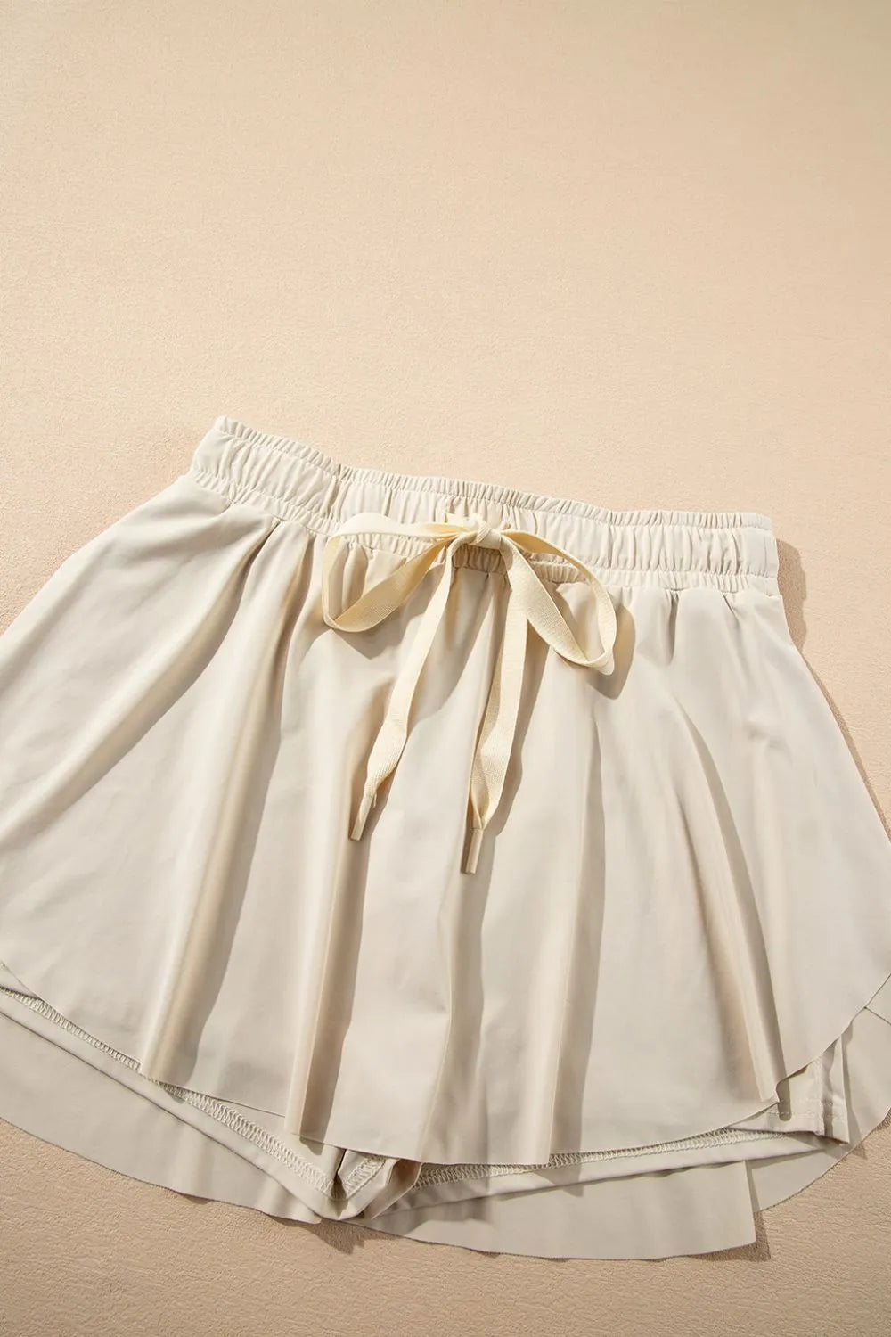 Top view of the Drawstring High Waist Lined Active Skorts featuring a comfortable drawstring waist and a soft, flowing design.