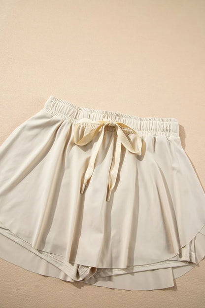 Top view of the Drawstring High Waist Lined Active Skorts featuring a comfortable drawstring waist and a soft, flowing design.