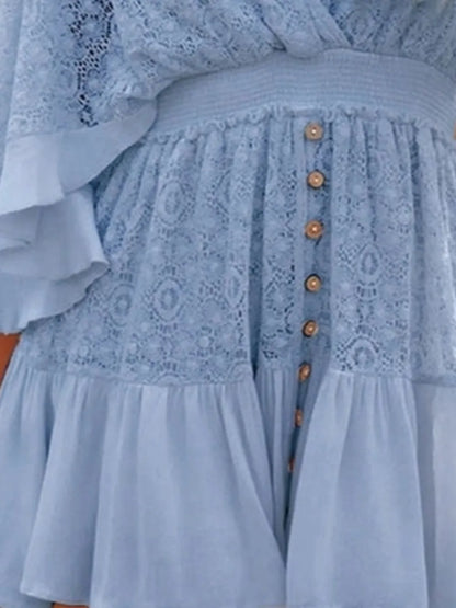 Detailed view of the front of the blue Semi-Sheer Ruffle Hem Lace Mini Dress With Tie Back - Elegant Smocked Design, focusing on button details and lace texture.
