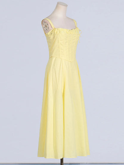 Trendy Slit Sleeveless Midi Dress with Zip Back in yellow, showcasing a side view with tied frill details and flowing skirt, made from 100% polyester.