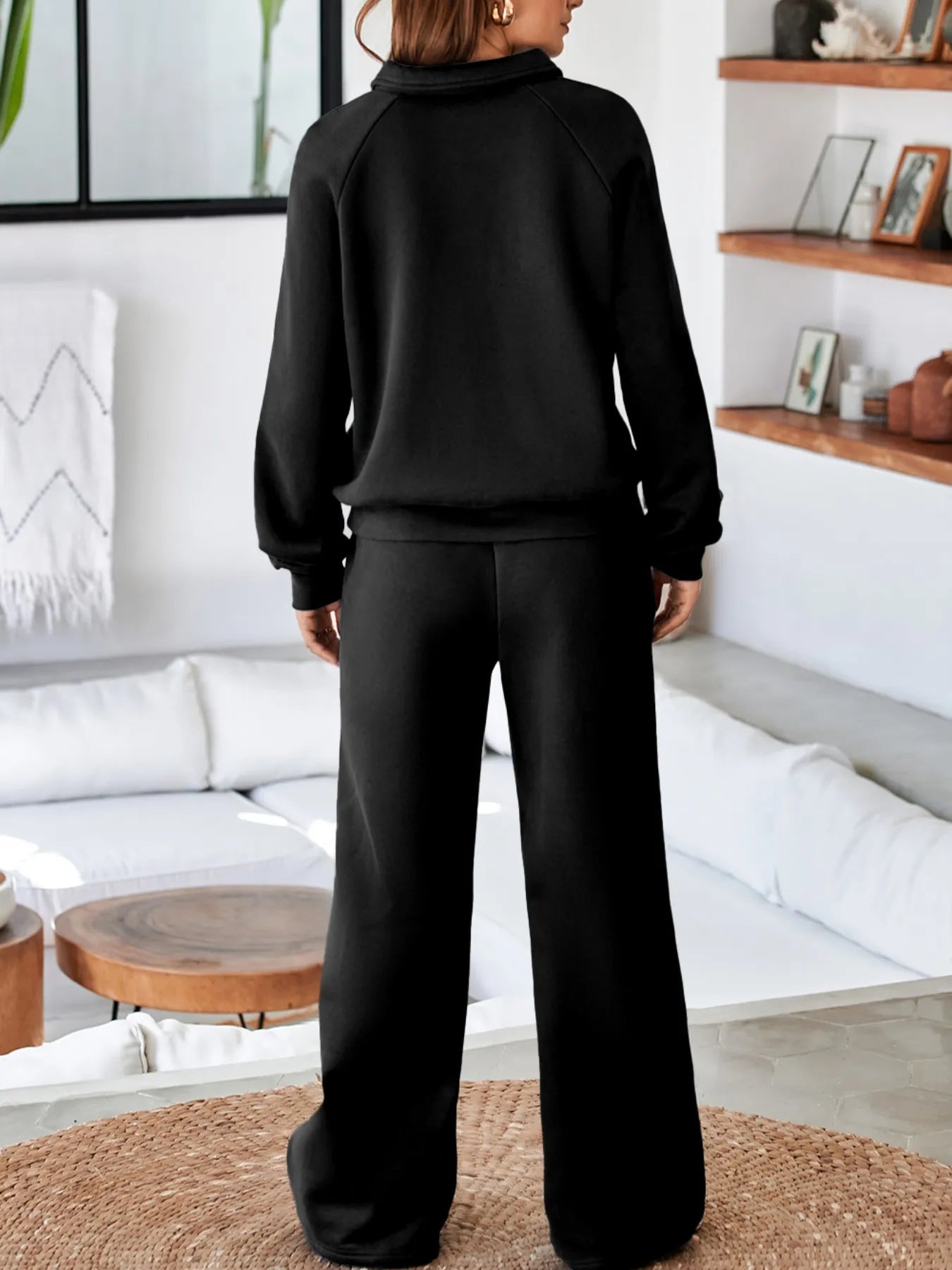 Back view of a model wearing the Trendsi Collared Sweatshirt & High Waist Pants Two-Piece Active Set - Soft Cotton Blend in black, highlighting the cozy fit.