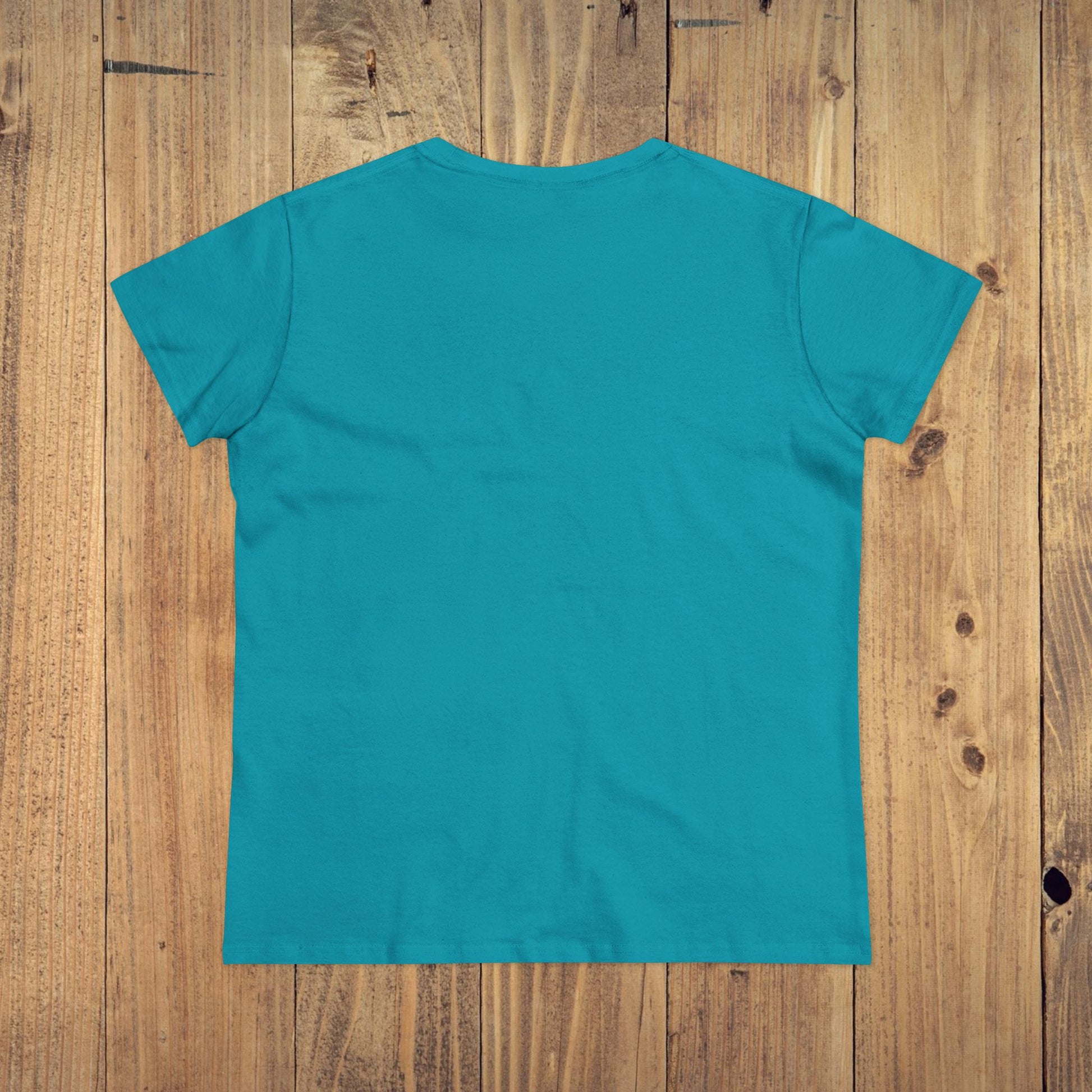 Back view of Stay Grounded Spiritual Tee in vibrant turquoise, designed for comfort at festivals and vacations, set against a wooden background.