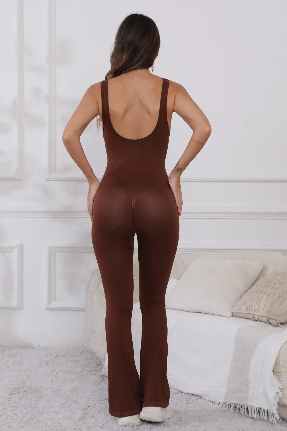 Scoop Neck Wide Strap Active Jumpsuit with Moderate Stretch - Comfortable & Stylish Fitness Wear. Rear view of the model in a brown jumpsuit, highlighting the flattering fit and stylish design.