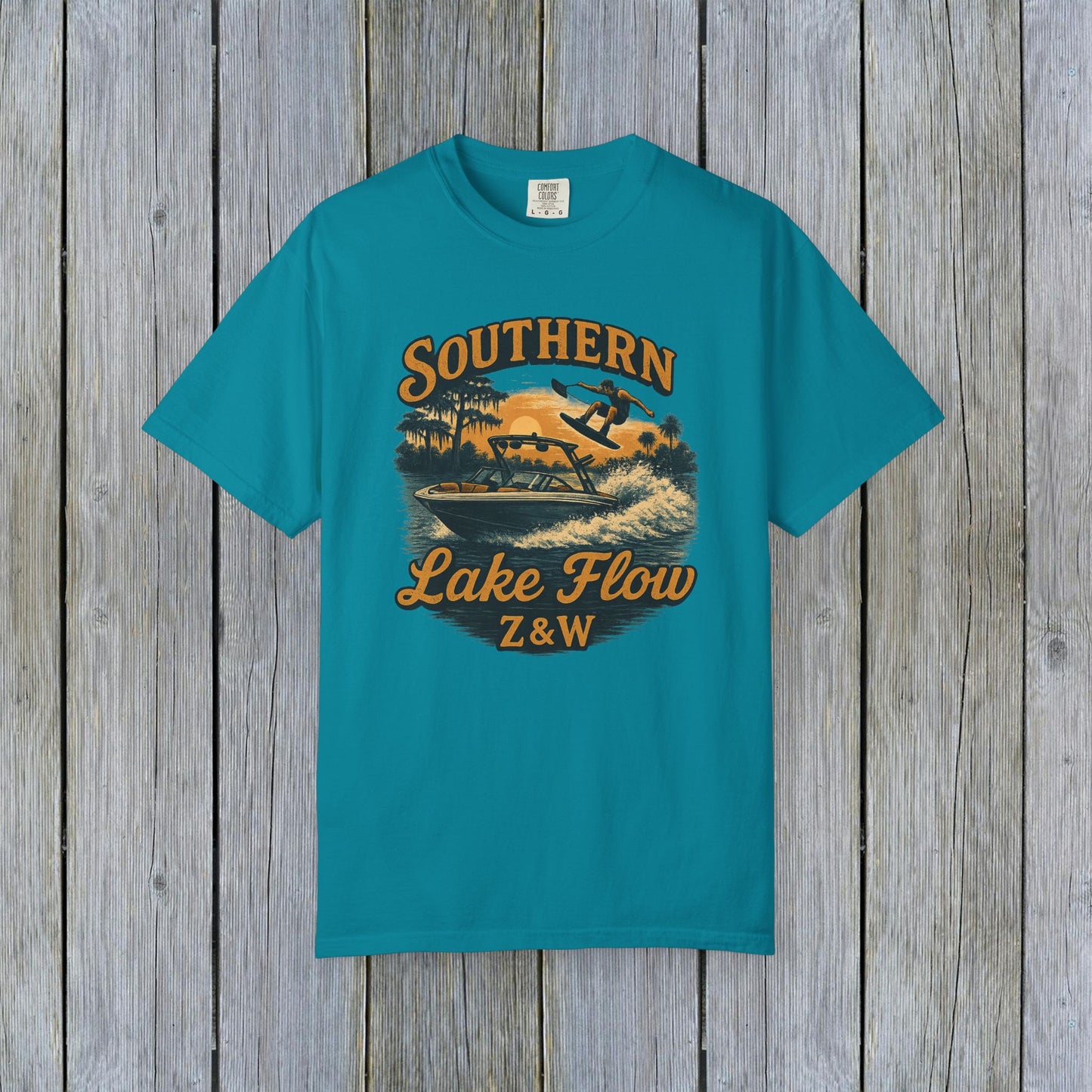 Southern Lake Flow T-Shirt in vibrant turquoise color, featuring a stylish graphic of a wakeboarder on a lake with a vintage design, perfect for eco-conscious fashion enthusiasts.