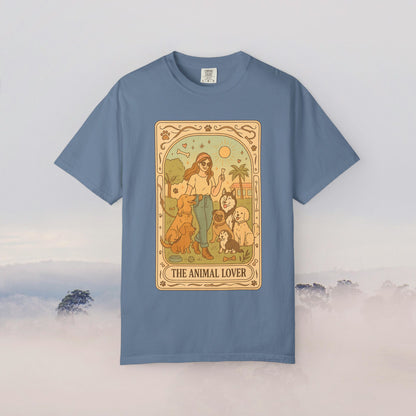 Animal Lover Tarot Tee in a soft blue hue, displaying an artistic representation of a woman surrounded by animals under the sun, ideal for those who cherish pets.
