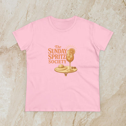 Soft pink Women's Midweight Cotton Tee with 'The Sunday Spritz Society' logo, ideal for sunny days and weekend adventures.