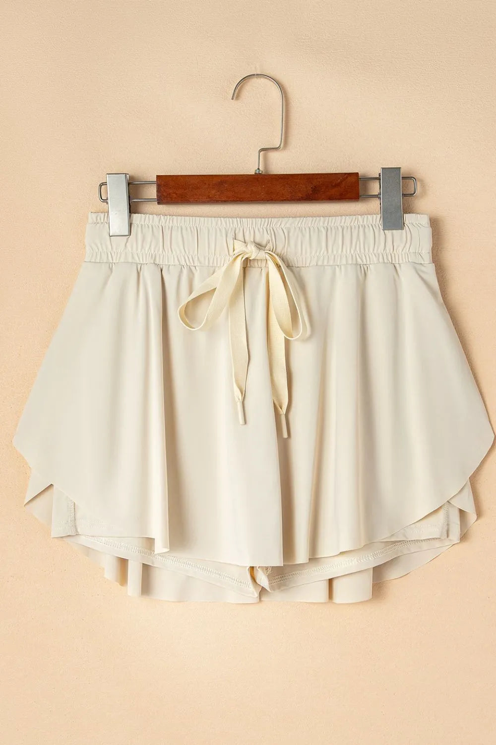 Flat lay of Drawstring High Waist Lined Active Skorts, featuring a drawstring waist and layered shorts for athletic comfort.
