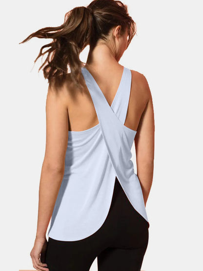Model wearing Crisscross Scoop Neck Tank Top for Active Wear in light blue, featuring a stylish back design with crisscross straps, perfect for workouts.