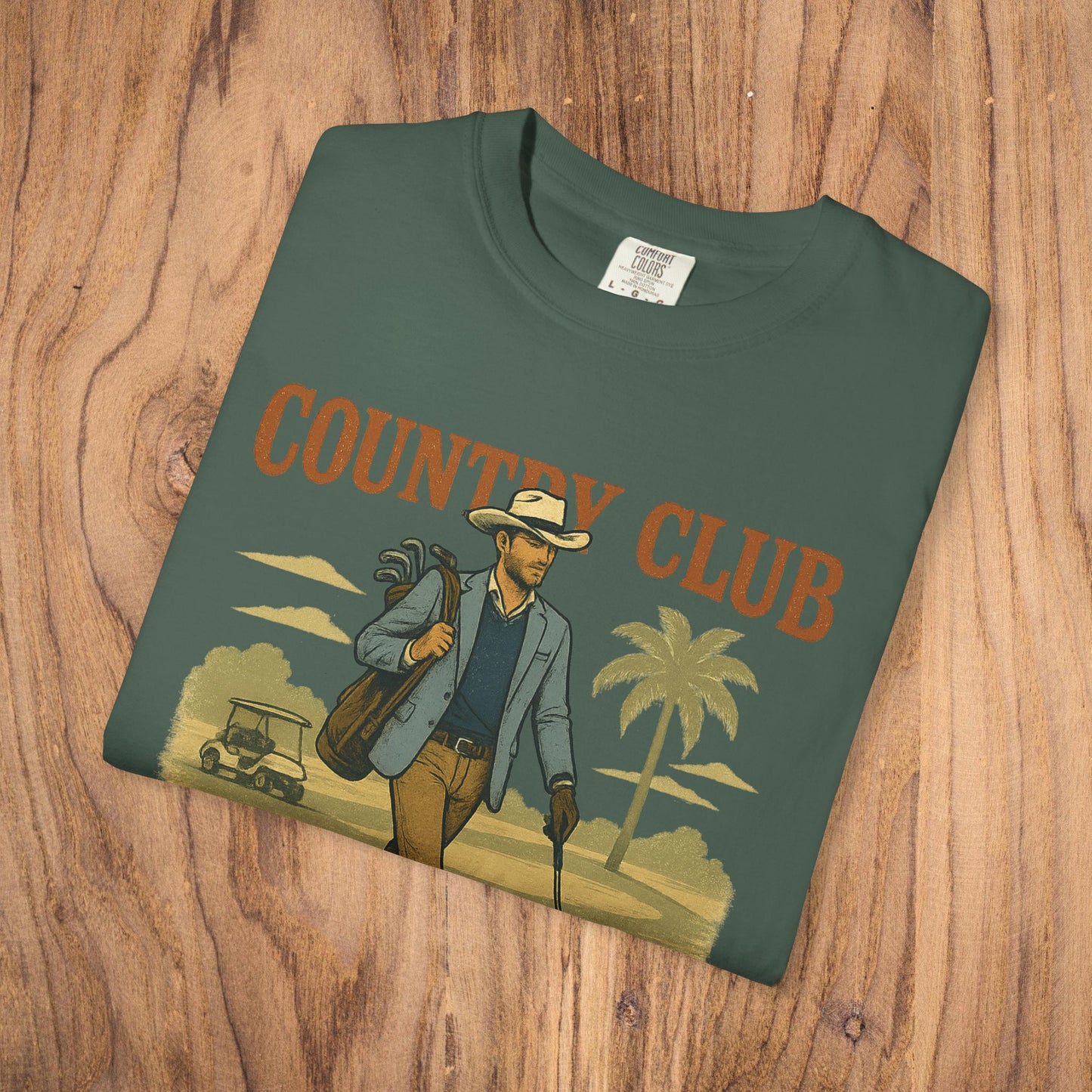 Front view of Country Club Cowboy Graphic Tee featuring a vibrant graphic of a cowboy holding golf clubs, emphasizing durability and style.