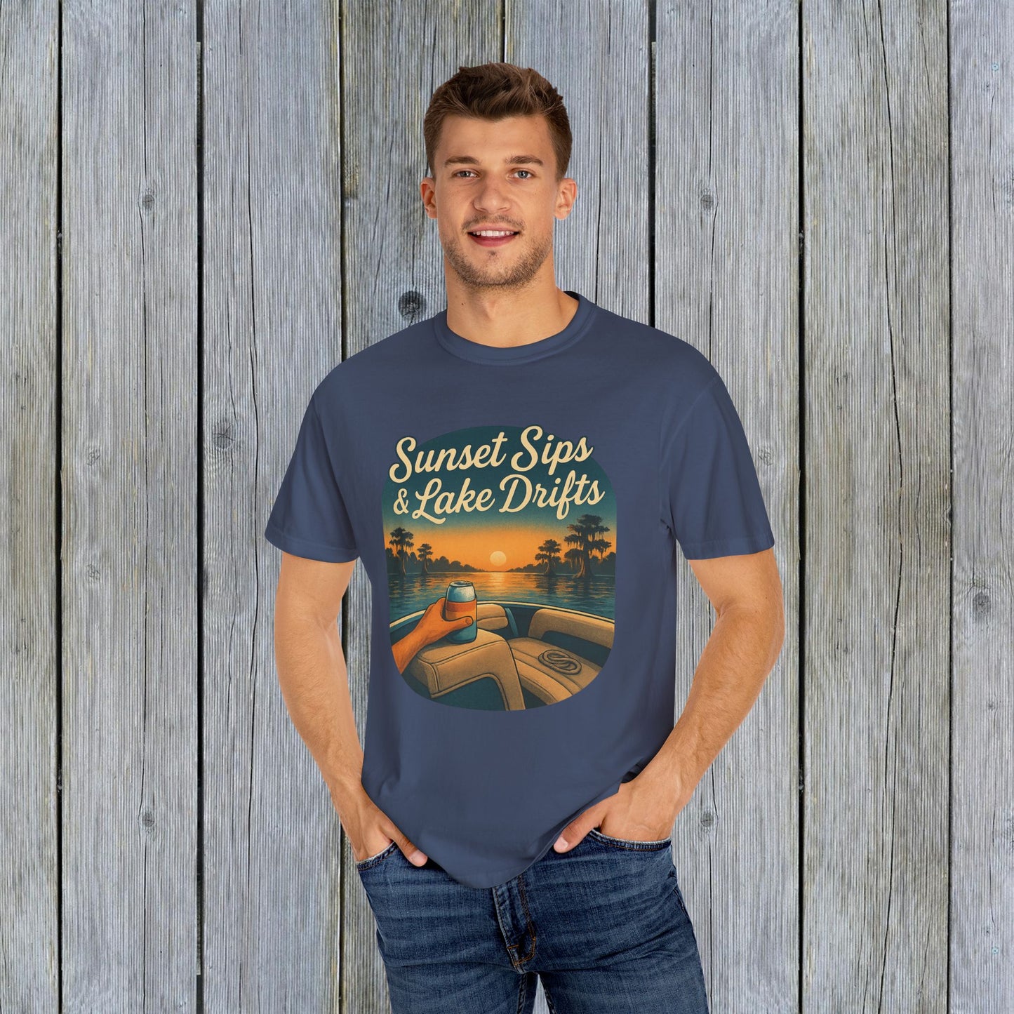 Man dressed in a navy Lake Drifts T-Shirt, featuring a vibrant sunset and lake design, made from soft and durable cotton.