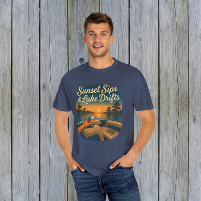 Man dressed in a navy Lake Drifts T-Shirt, featuring a vibrant sunset and lake design, made from soft and durable cotton.