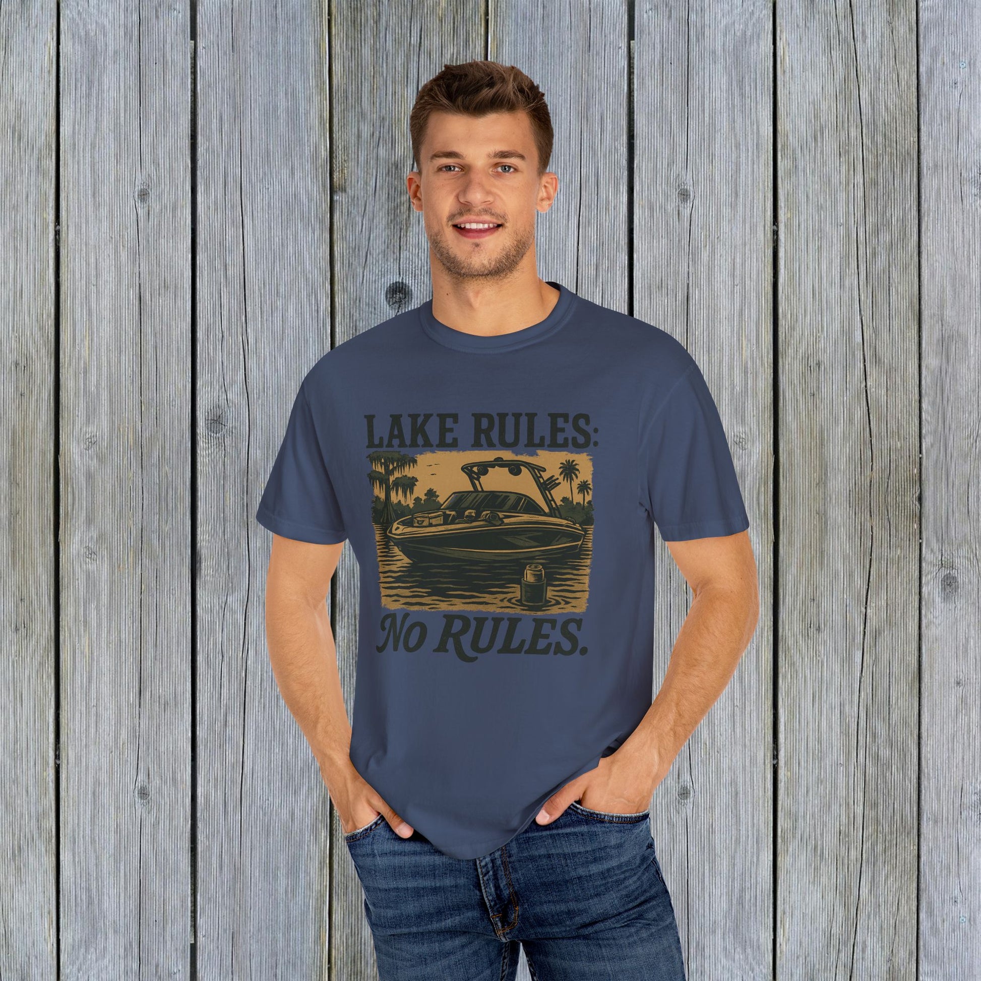 Unisex Garment-Dyed Lake Rules Tee - Soft Vintage Fabric, Sizes S to 4XL, perfect for outdoors, modeled by a male against a wooden background, promoting relaxed outdoor style.