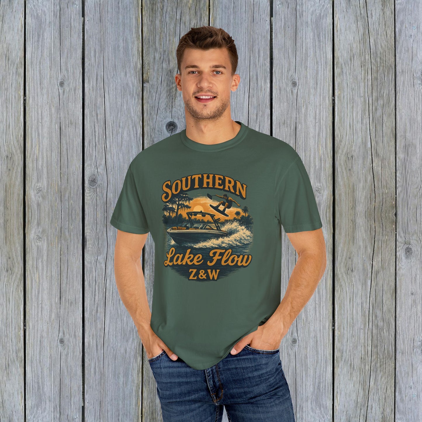 Man proudly wearing the Southern Lake Flow T-Shirt in olive green, perfect for casual outings, showcasing its eco-friendly production and stylish graphic.