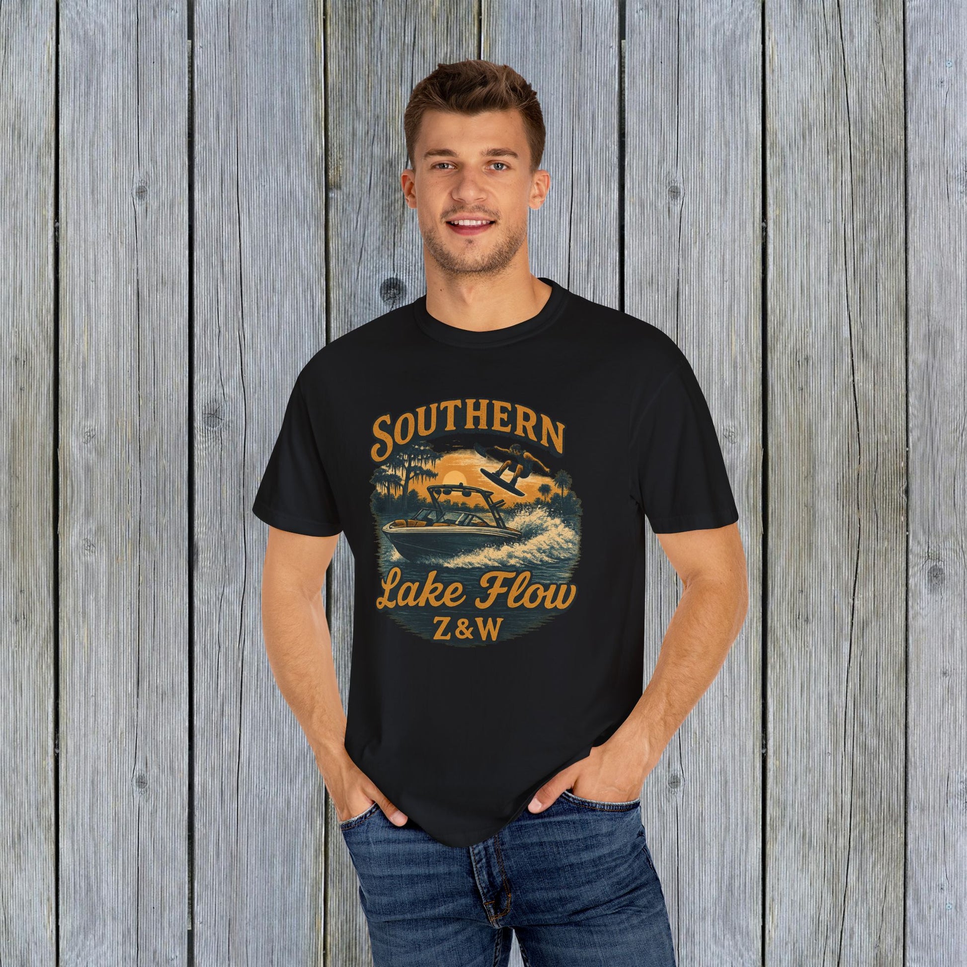 Man in a black Southern Lake Flow T-Shirt, highlighting eco-friendly 100% US cotton fabric. Ideal for stylish beach and lake activities.