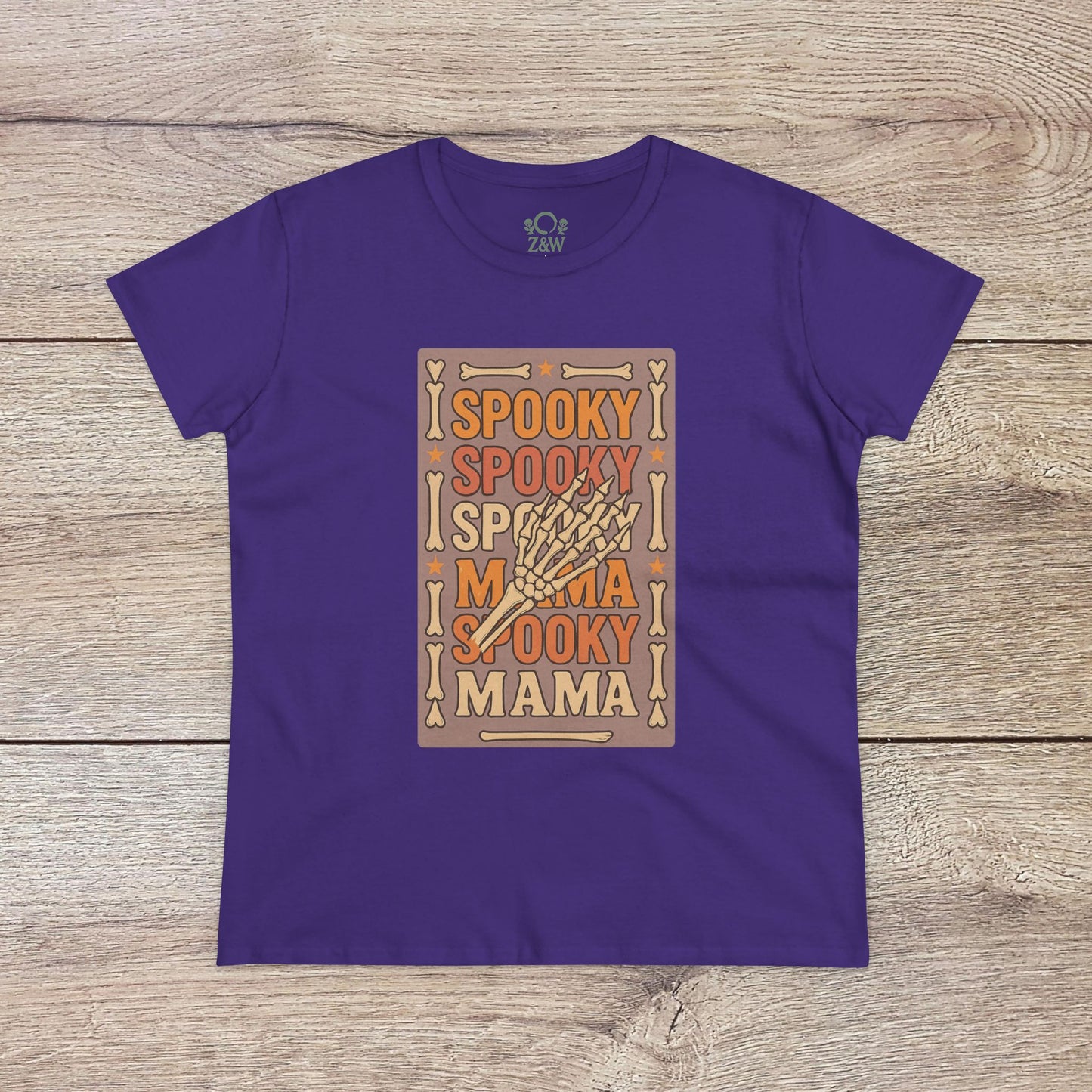 Spooky Mama Tee in purple showcasing a playful skeleton hand design, crafted from durable soft cotton for all occasions.