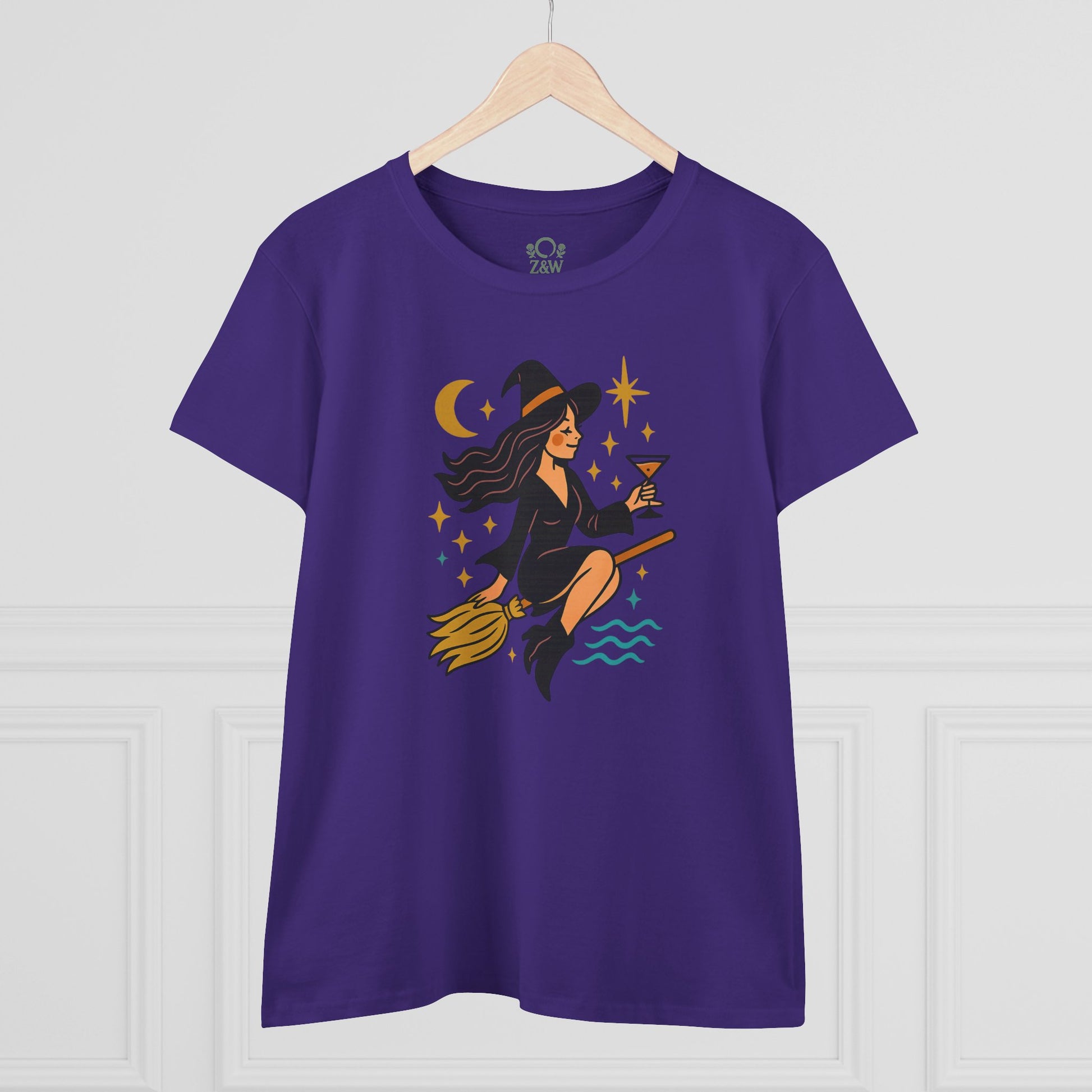 Front view of the Witchy Night Out Tee in purple showcasing a unique design with a witch on a broomstick, perfect for stylish, durable, and ethically made wear.